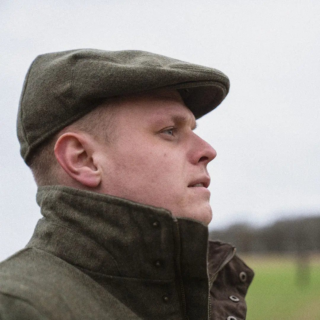 Flat cap worn outdoors, showcasing the Seeland Hillside Sixpence Hat for country clothing