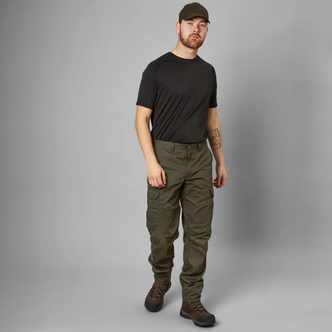 Man in black t-shirt and cargo pants showcasing Seeland Oak Trousers for casual style