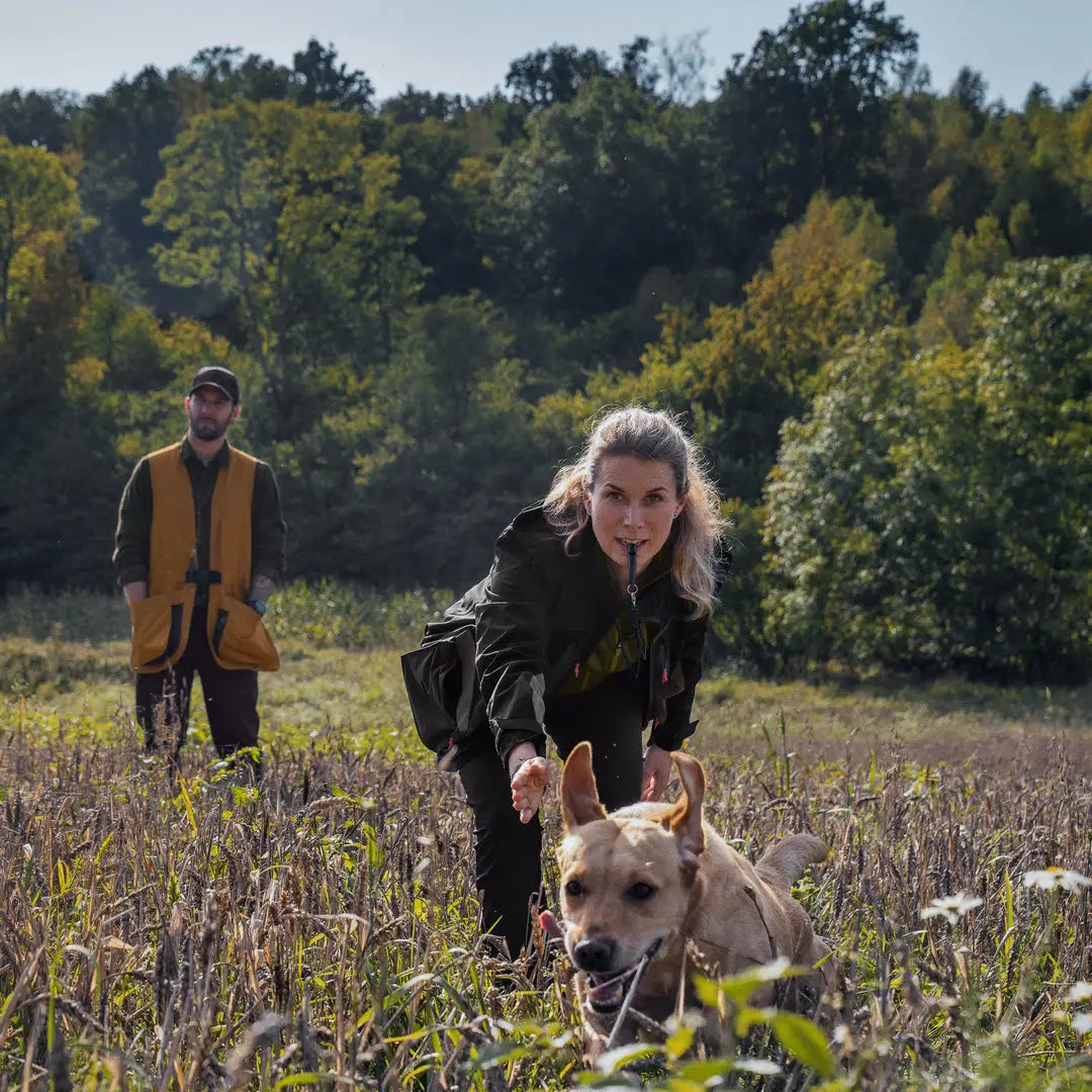 Dog being walked through wildflowers in a stylish Seeland Women’s Dog Active Jacket