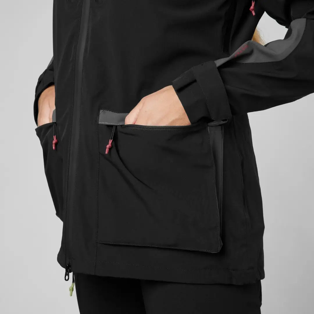 Black shell jacket for women with pockets and red zipper pulls, perfect for dog active outings