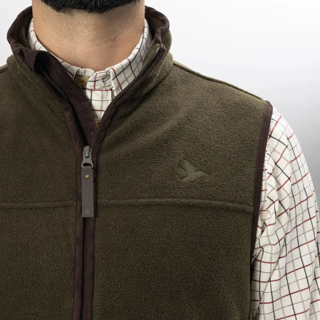 Olive green Earl Fleece Waistcoat over a stylish checkered shirt. Perfect for outdoors!