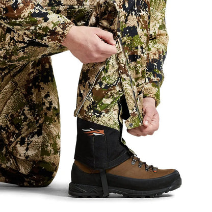 Camouflage hunting boot with brown leather and black rubber sole for typical rain gear