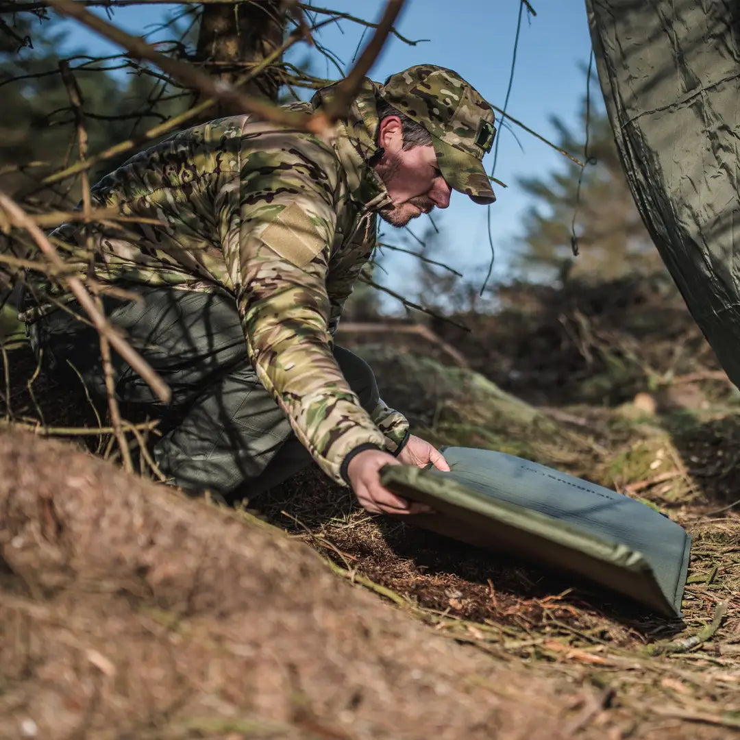 Soldier in camouflage grabs a Snugpak Self-Inflating Maxi Mat on the ground