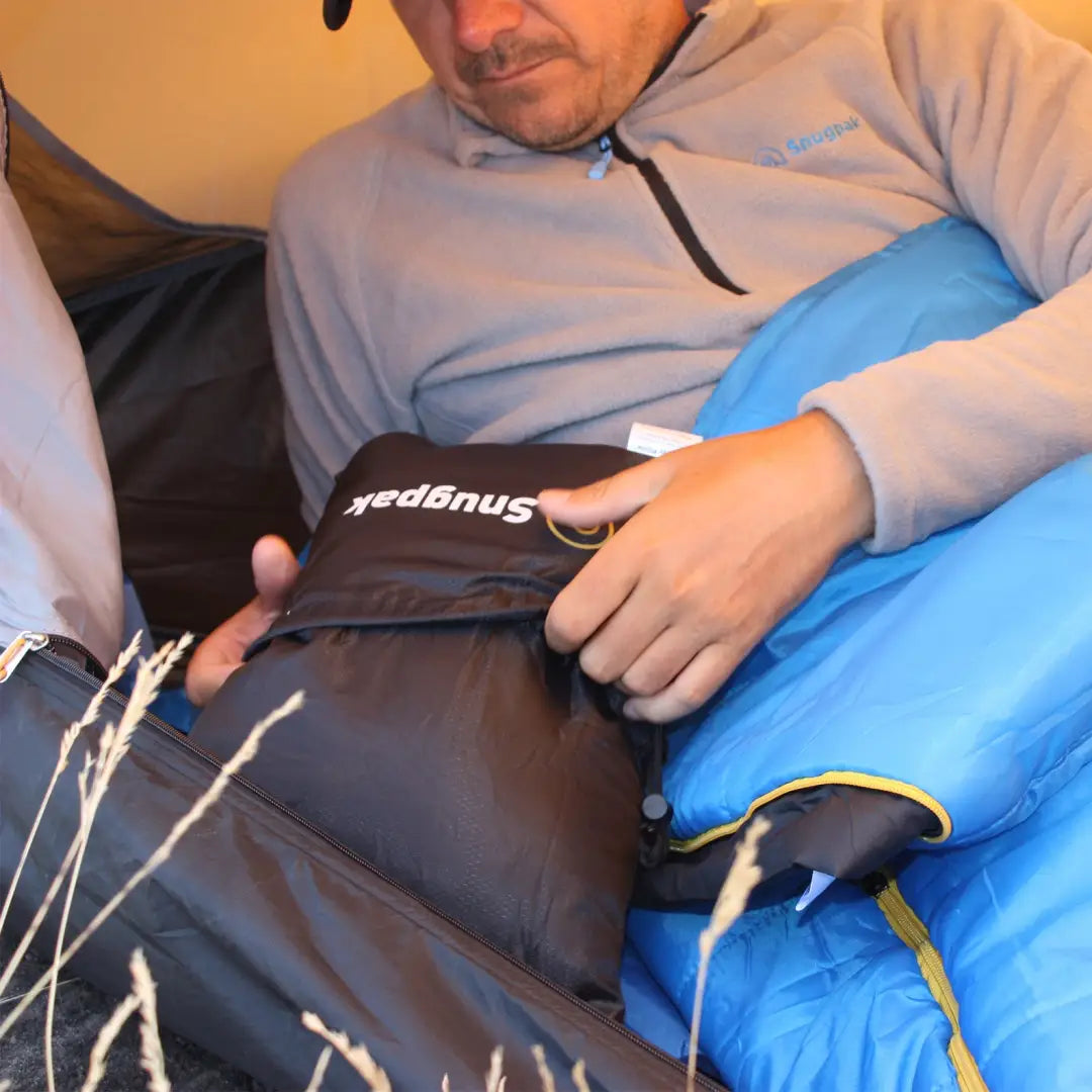 Ice pack on a hip for recovery in Snugpak Snuggy Headrest, perfect for country clothing adventures