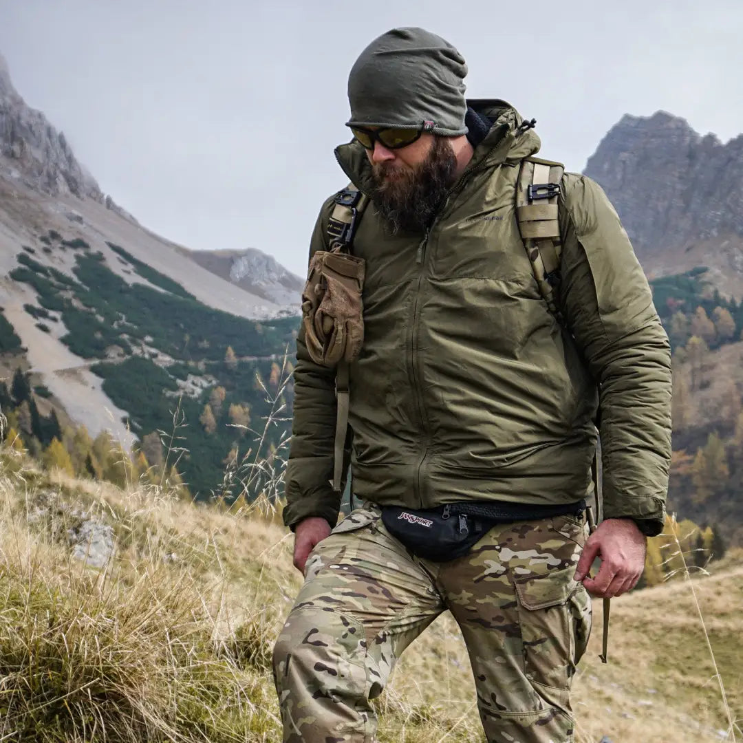 Bearded man in Snugpak Spearhead Technical Midweight Jacket hiking mountains