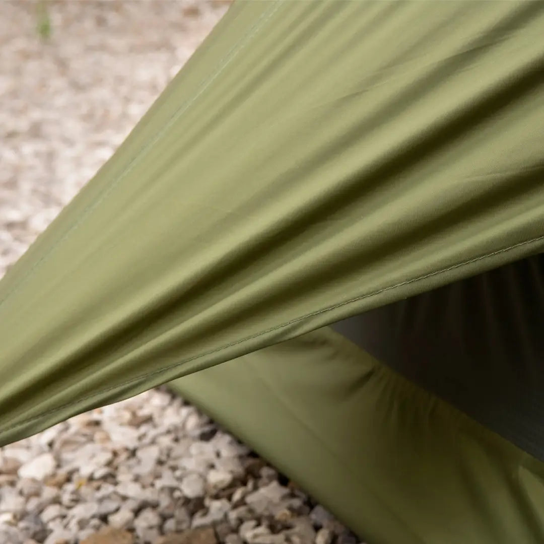 Olive green bivvi shelter by Snugpak pitched on rocky ground for increased breathability