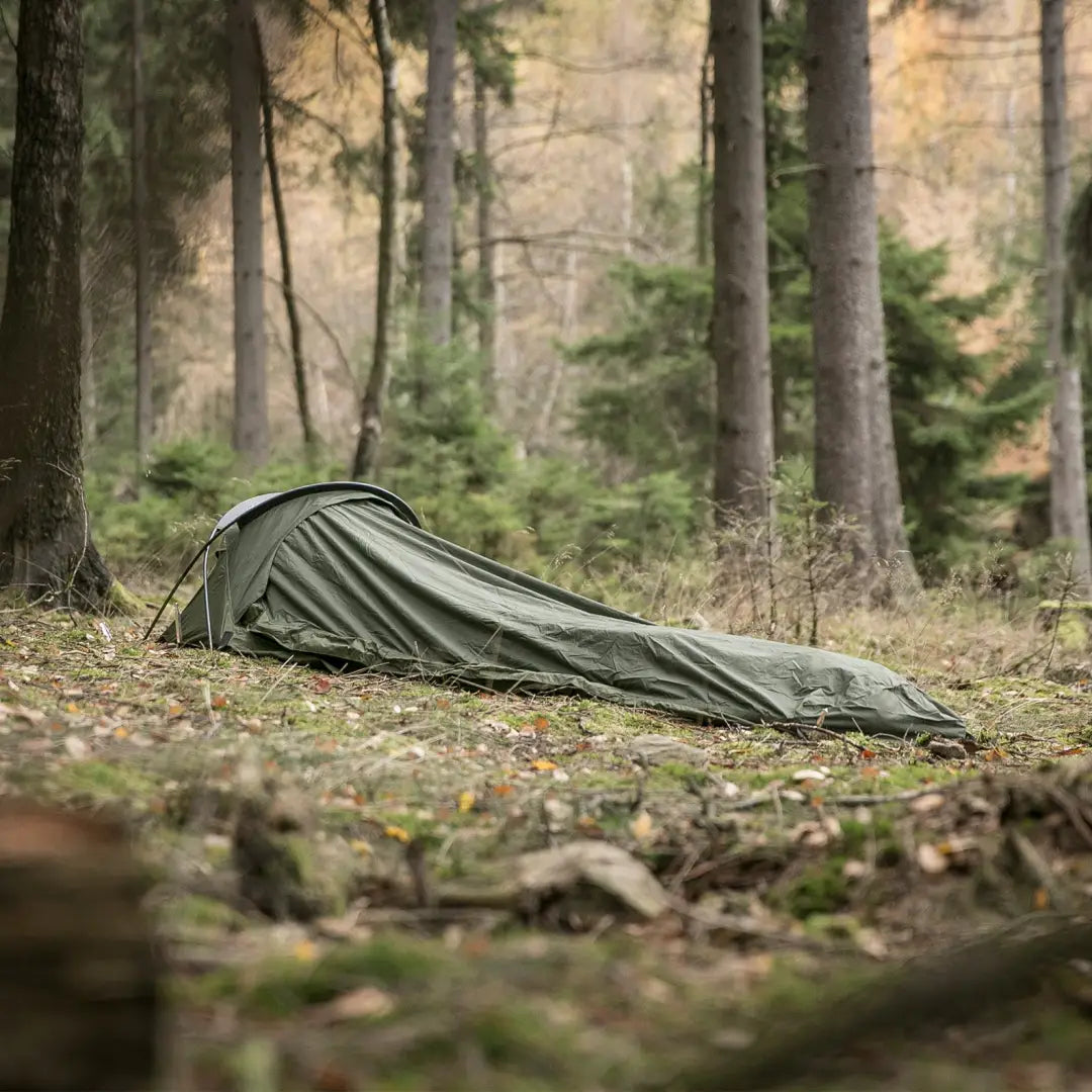 Olive green Snugpak Stratosphere bivvi shelter on forest floor for increased breathability