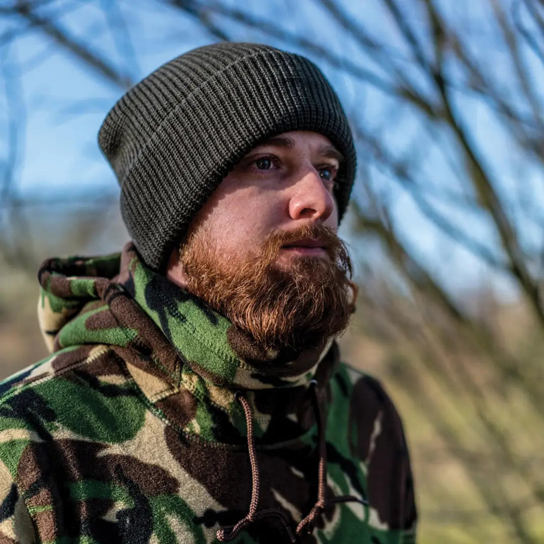 Man in a green knit hat and camo jacket showcasing the Speero Bob Hat