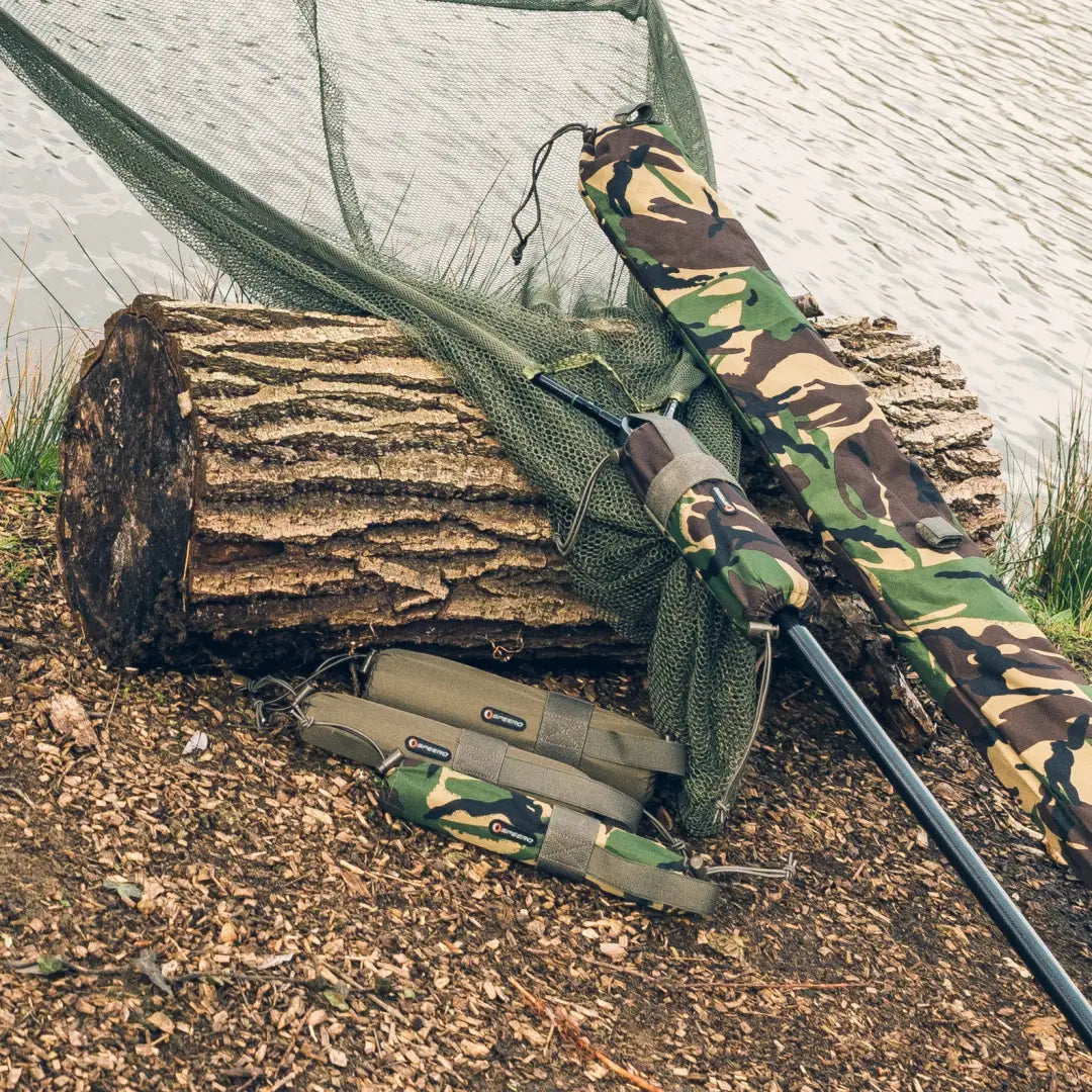 Fishing rod with camouflage lean on log next to Speero Net Retention Float XL