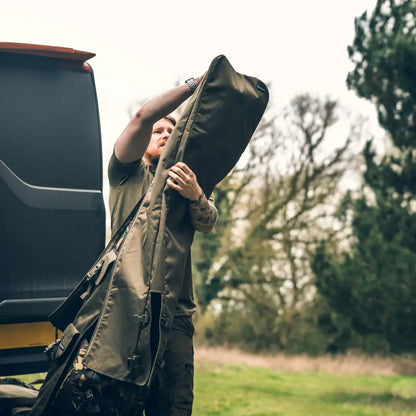 Person loading a Speero Quiver into a vehicle for country clothing adventures