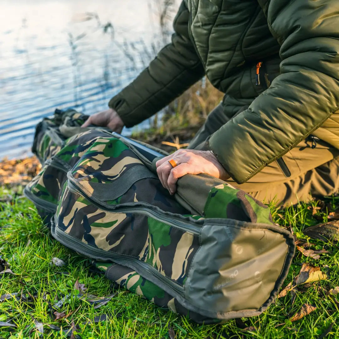 Camouflage Speero Retractable Rod Bag opened by water for easy fishing gear access