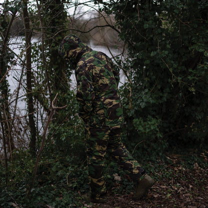 Camouflaged hooded figure wearing a Sirius Tech-Lite Jacket in tough weather conditions