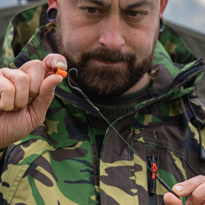 Fishing hook with orange bait, perfect for use with the Sirius Tech-Lite Jacket in any weather conditions