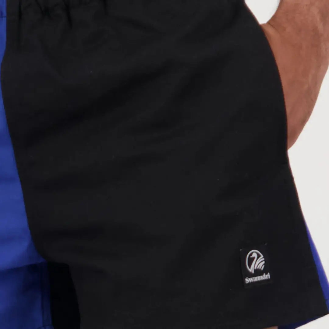 Black and blue athletic shirt with logo paired with Swanndri Cotton Harlequin Rugby Shorts