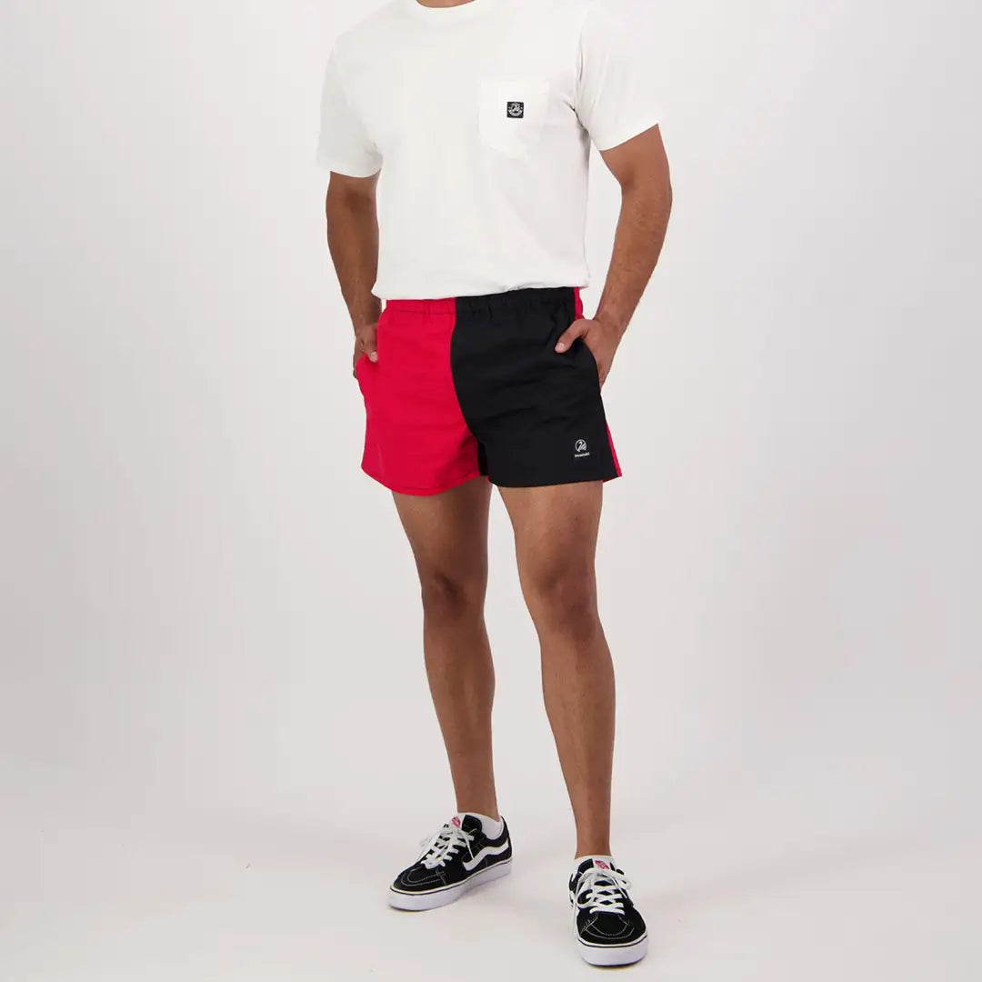 Person in Swanndri Cotton Harlequin Rugby Shorts with white t-shirt and sneakers