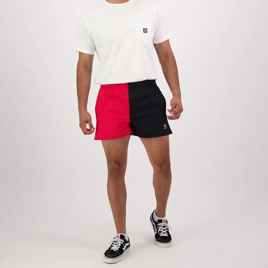 Swanndri Cotton Harlequin Rugby Shorts in red and black, styled with a white tee and sneakers