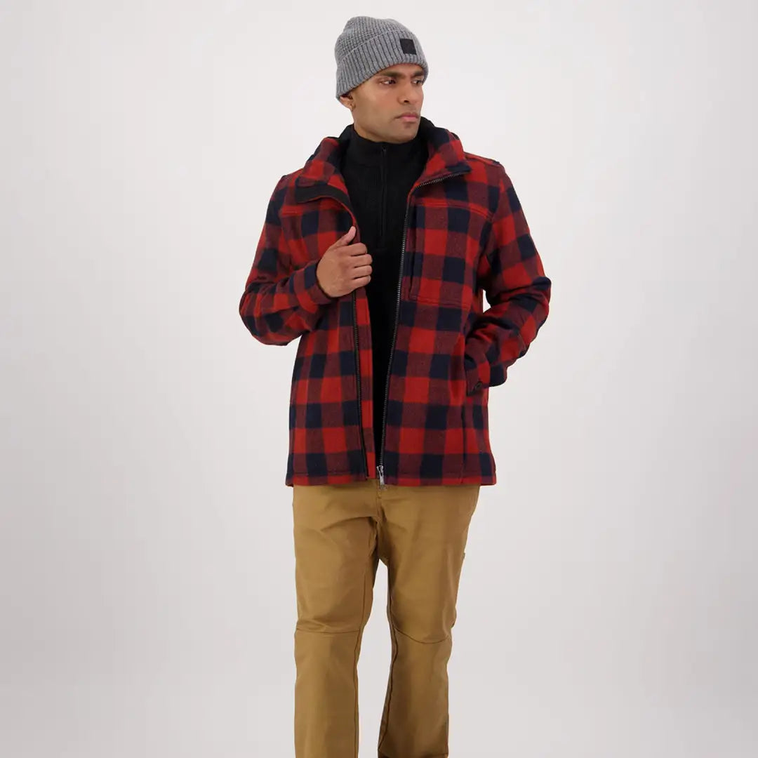 Person wearing a red and black plaid flannel jacket with the Hudson Wool Hoody