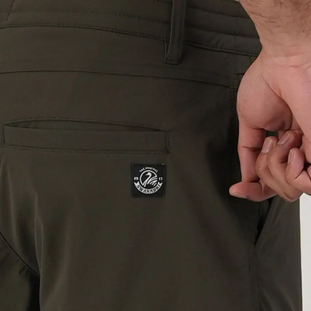 Dark green Lawson Walk Shorts featuring a cool circular logo patch on the pocket