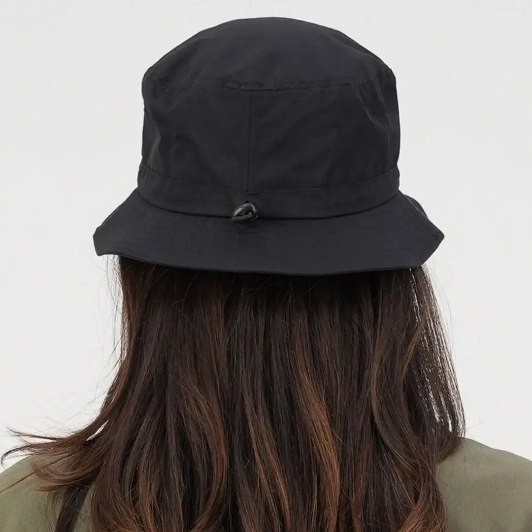 Black Swanndri Murrays Bay V2 Bucket Hat on a person with long brown hair