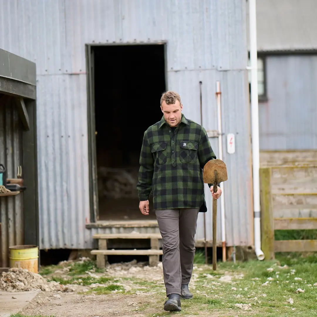 Man in a green plaid jacket walking outside, rocking the Swanndri Ranger Extreme V2