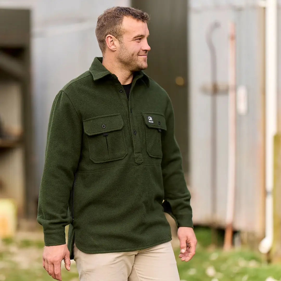 Man wearing a dark green Ranger Bush Shirt with chest pockets for outdoor adventures