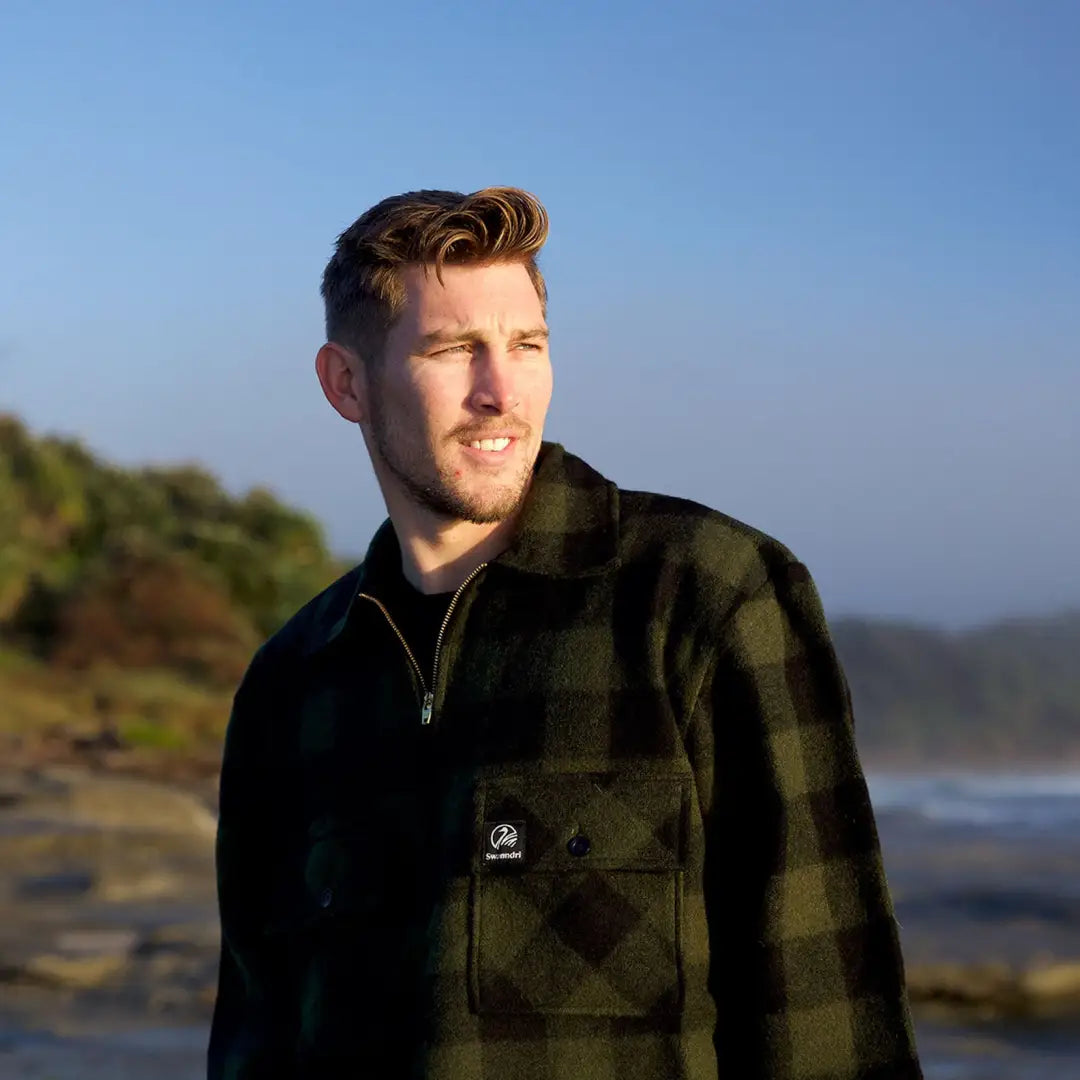 Man in dark plaid jacket outdoors wearing a Swanndri Ranger bush shirt