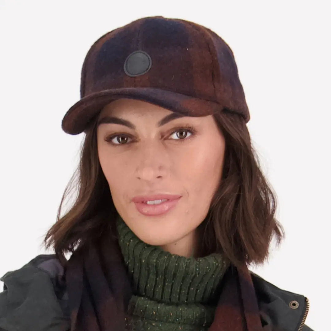 Woman in a brown Swanni Wool Baseball Cap and green turtleneck sweater