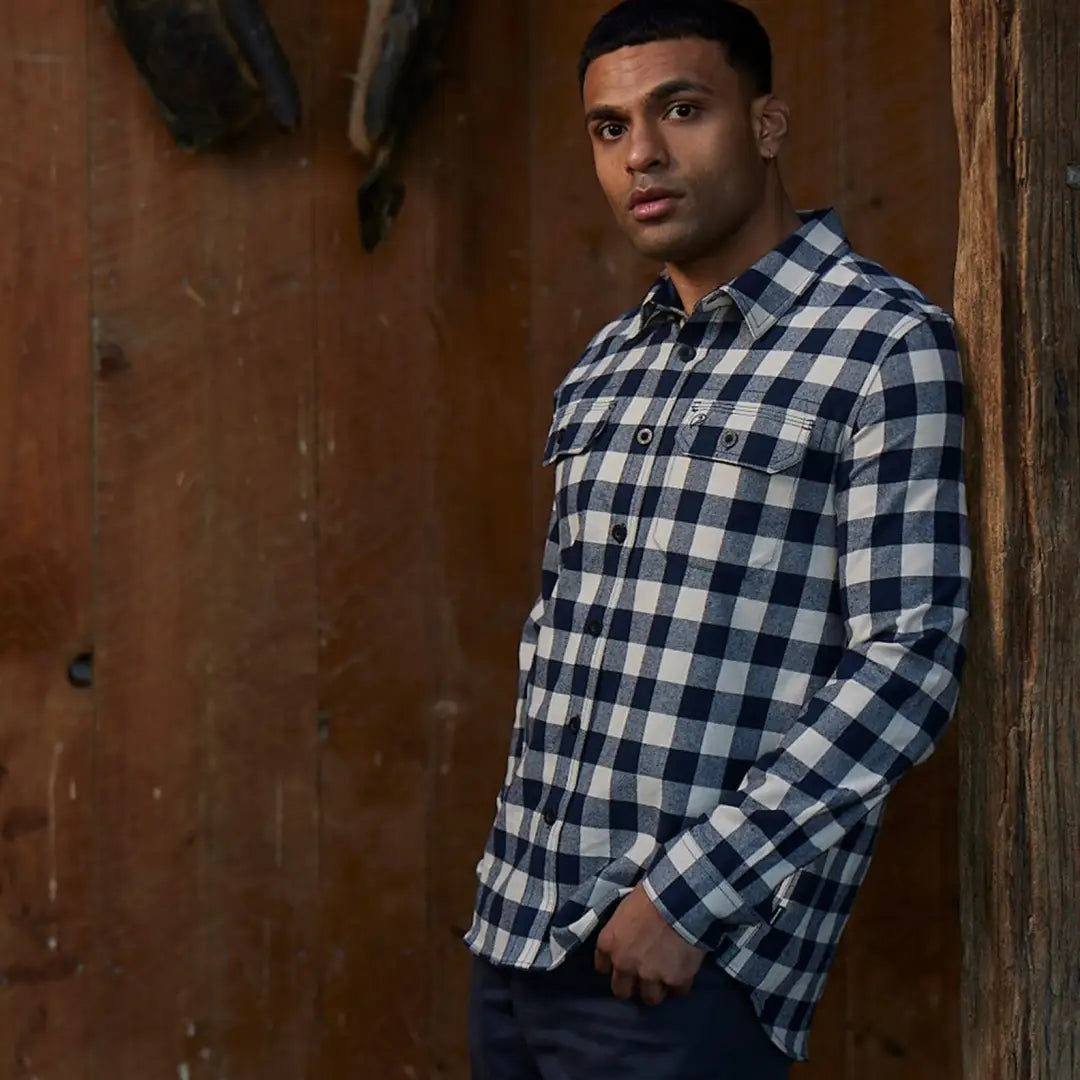 Man in a checkered flannel shirt from Taranaki Tailor perfect for country clothing or hunting