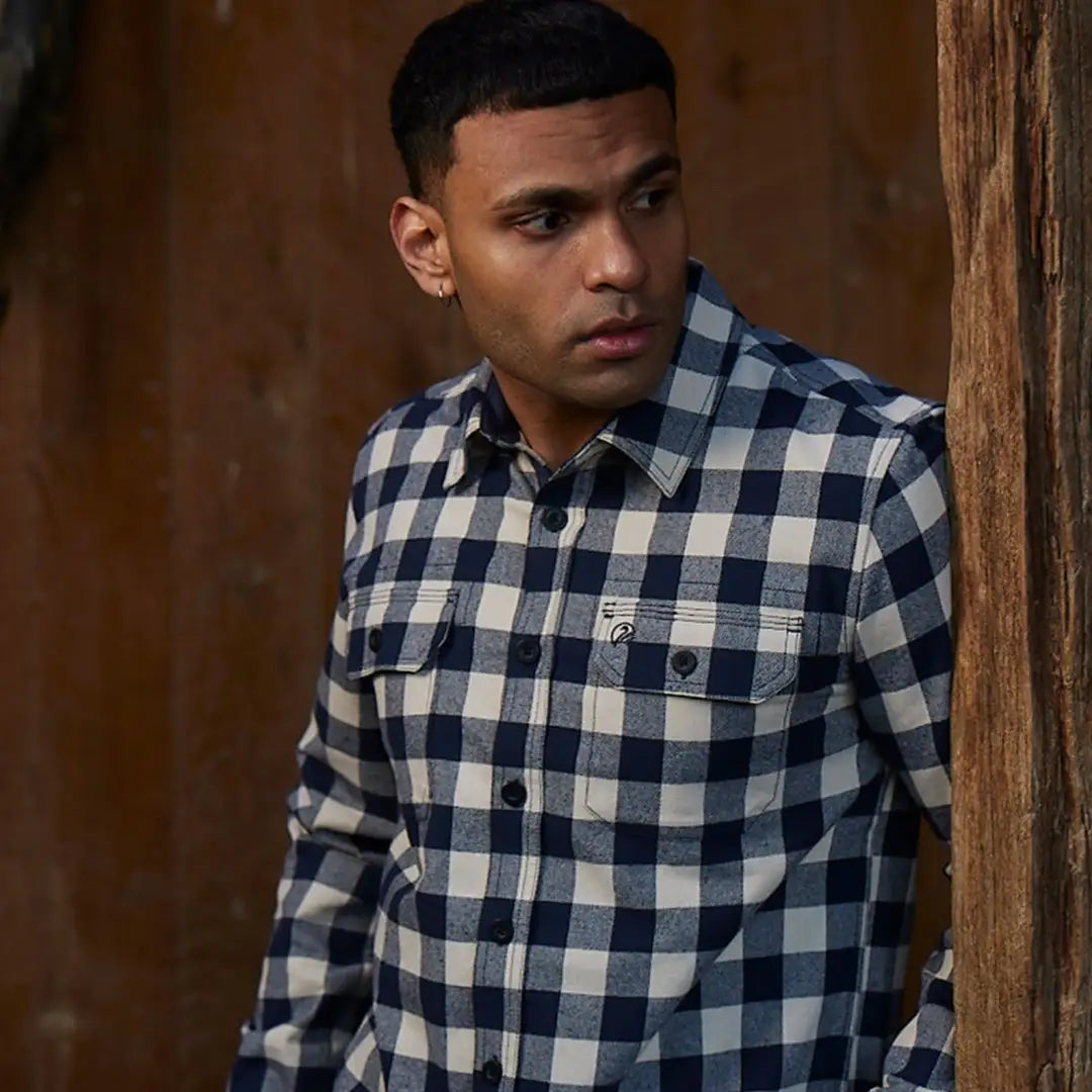 Man in a blue and white checkered flannel shirt from Taranaki Tailor for country clothing