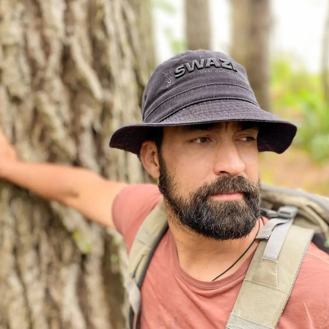 Man in a gray SWAT bucket hat rocking country clothing for hunting and outdoor fun