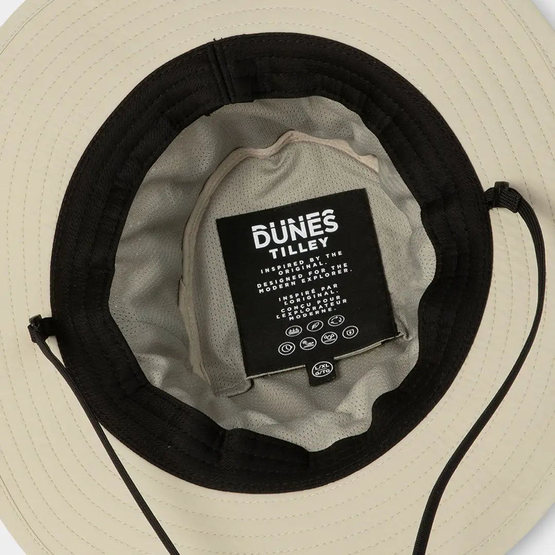 Cream-colored Tilley Dunes Explorer Hat with black band and Dunes Valley label inside