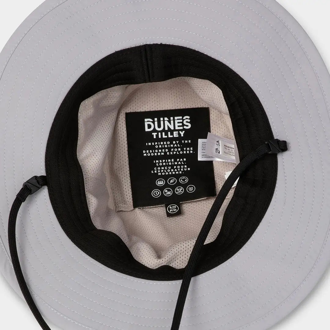 Beige and black Dunes Explorer Hat with DUNES TILLEY label for stylish adventure vibes