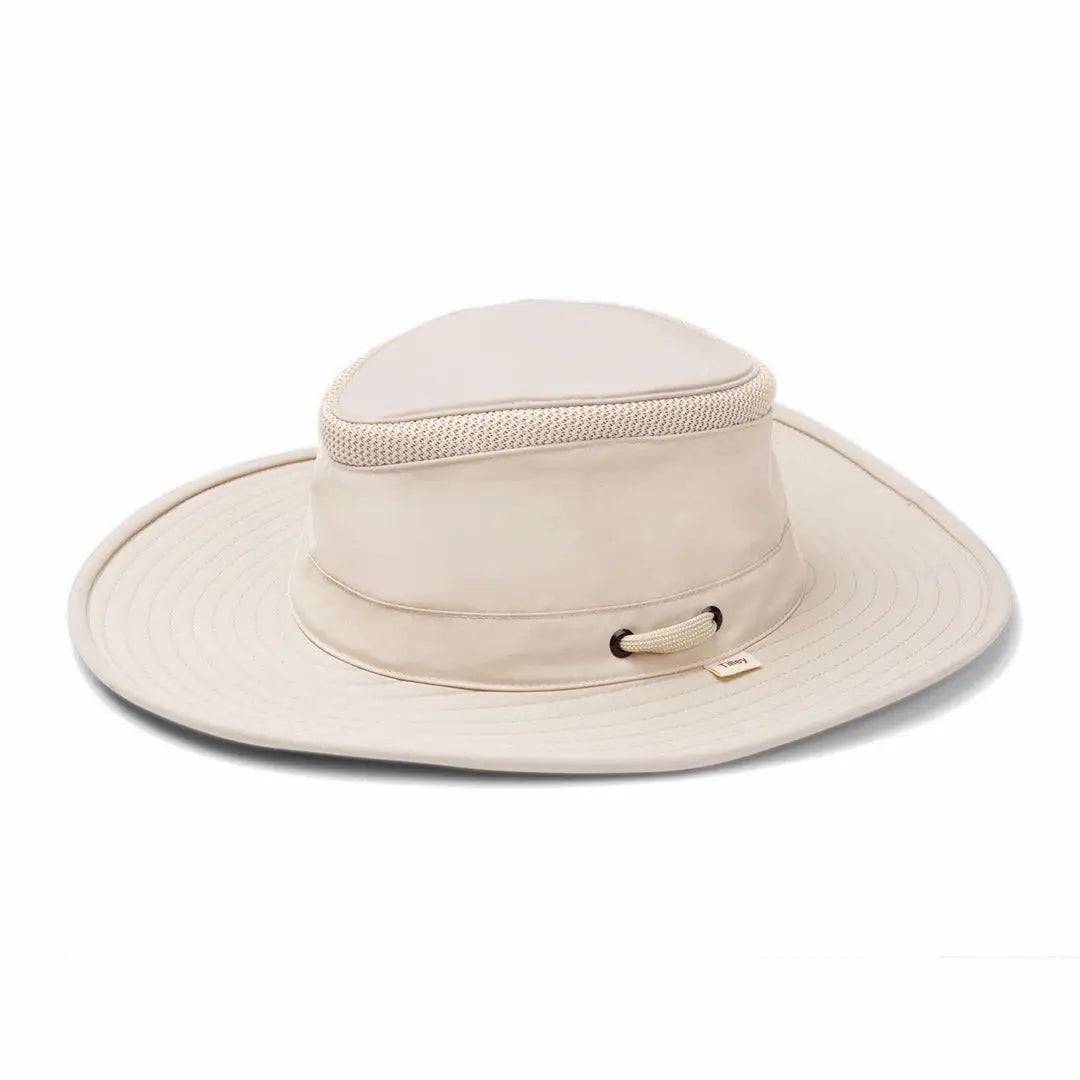 Wide-brimmed beige Tilley LTM6 Airflo Hat with a stylish decorative band