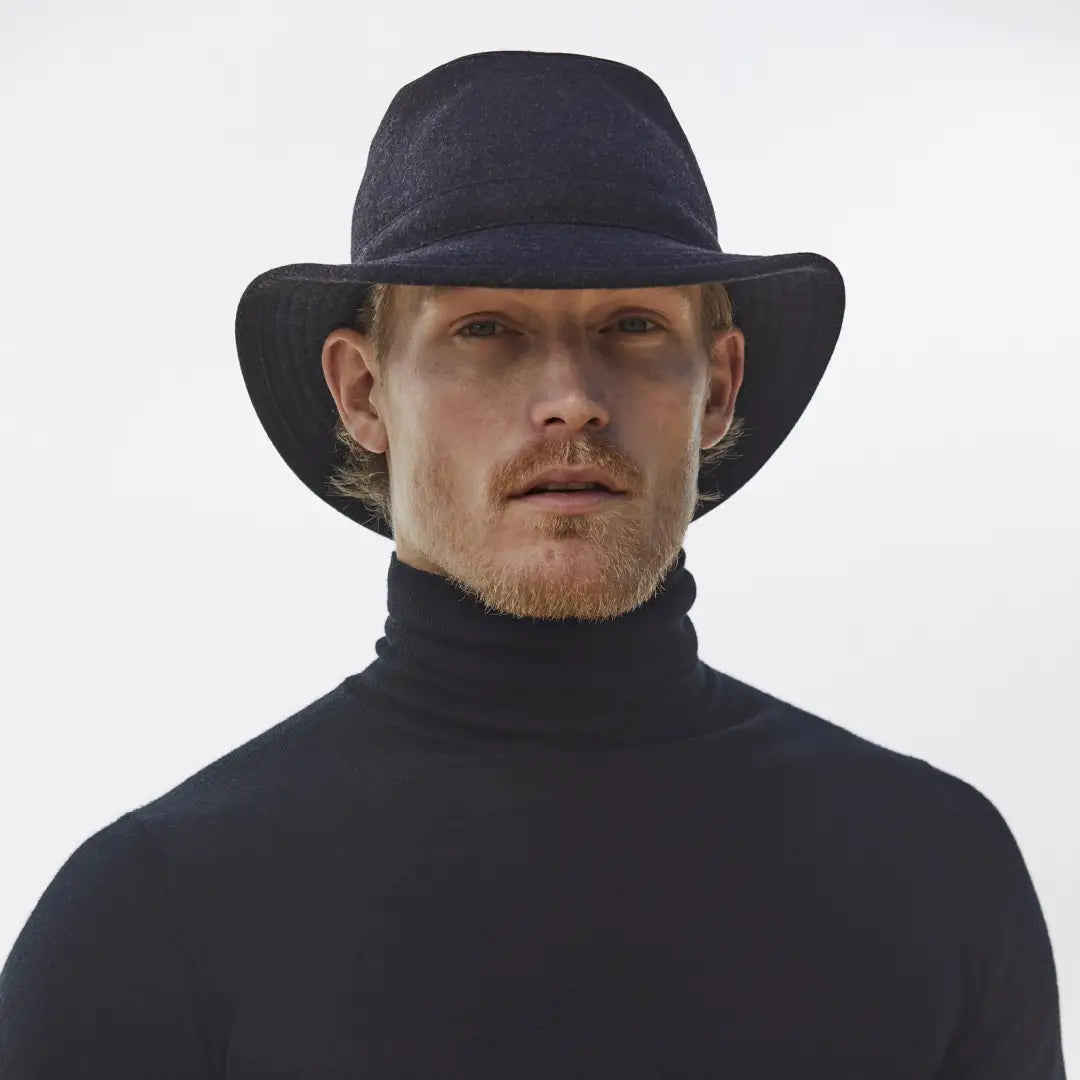 Man in black hat and turtleneck showcases Tilley TTW2 for stylish country clothing