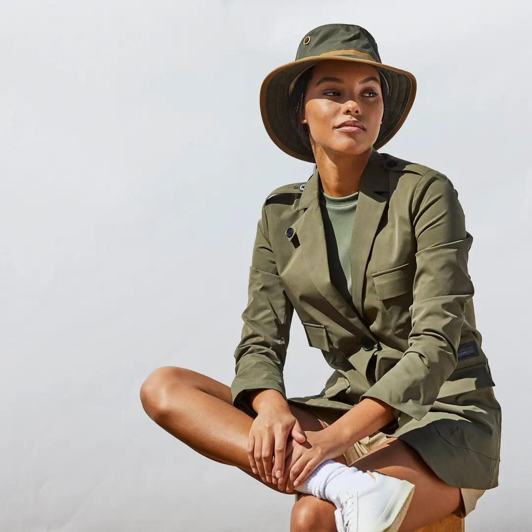 Woman in a khaki safari outfit rocking the Tilley TWC7 Outback Waxed Cotton Hat