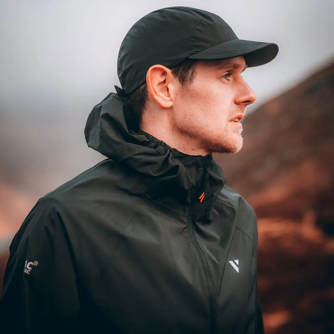 Profile view of a person in a lightweight stretch running jacket outdoors