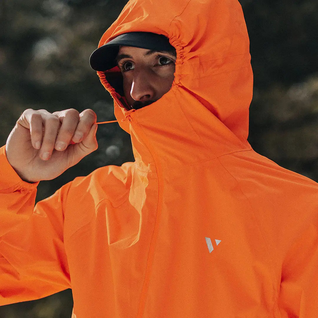 Bright orange Venture Ultralight running jacket on a person, experience ultimate performance