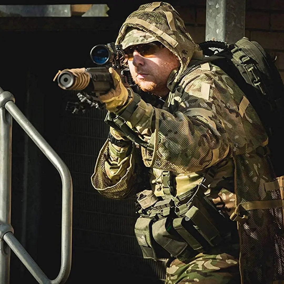 Soldier in camouflage uniform aiming a rifle, showcasing the Viper Concealment Vest