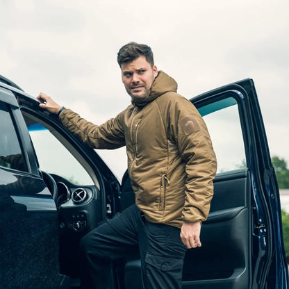 Man in a tan Viper Frontier Jacket stepping out of a black vehicle for fast-changing climates