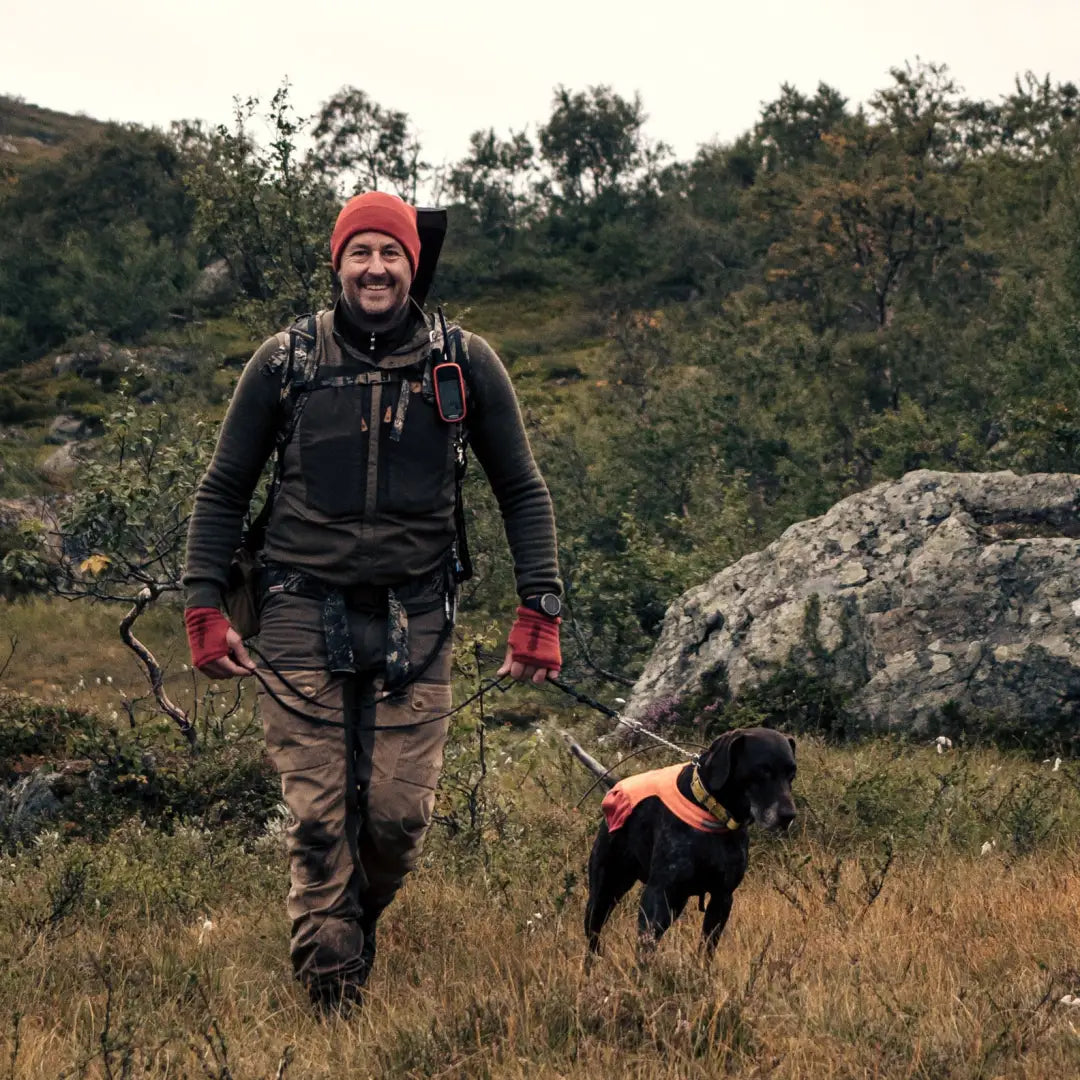 Hiker in country clothing with a dog enjoying the outdoors in Woolpower Zip Turtleneck